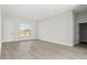 Bright living room area showcasing hard surface floors and access to other rooms in the house at 6084 Sw 150Th Ln, Ocala, FL 34473