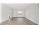 Spacious living room with hard surface flooring and natural light from the front window at 6084 Sw 150Th Ln, Ocala, FL 34473