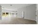 Open concept living space with modern lighting and a view to the kitchen and back yard at 6084 Sw 150Th Ln, Ocala, FL 34473