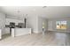 Open concept living space featuring an island kitchen, hard surface floors and modern design at 6084 Sw 150Th Ln, Ocala, FL 34473