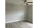 Bedroom featuring new gray vinyl plank flooring, neutral walls, and a ceiling fan at 635 Malaga Ave, Deltona, FL 32725