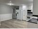 Open-concept kitchen flows into dining area, featuring white cabinets and stainless-steel appliances at 635 Malaga Ave, Deltona, FL 32725