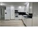 A kitchen featuring white cabinets, light gray walls, and neutral flooring at 635 Malaga Ave, Deltona, FL 32725