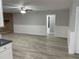 A spacious room with gray walls, brick fireplace, and wood-look flooring at 635 Malaga Ave, Deltona, FL 32725