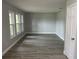 Bright living room with new gray vinyl plank flooring and windows providing natural light at 635 Malaga Ave, Deltona, FL 32725