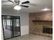 Living room with ceiling fan, wood burning fireplace, and sliding doors to the screened in lanai at 635 Malaga Ave, Deltona, FL 32725