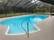 Sparkling blue pool with a screened enclosure and patio perfect for outdoor entertaining at 635 Malaga Ave, Deltona, FL 32725