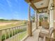 Enjoy golf course views from this balcony with outdoor seating at 7407 Excitement Dr, Reunion, FL 34747