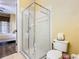 Shower with glass door inside a bathroom that connects to a bedroom at 7407 Excitement Dr, Reunion, FL 34747