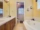 Bathroom showcasing a double vanity and large soaking tub at 7407 Excitement Dr, Reunion, FL 34747