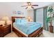 Inviting bedroom with a plush blue bed, elegant curtains, and warm ambient lighting at 7407 Excitement Dr, Reunion, FL 34747