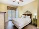 Comfortable bedroom features stylish decor, wood floors, and a door to the outside at 7407 Excitement Dr, Reunion, FL 34747