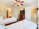 Cozy bedroom has two twin beds, warm lighting, and access to en-suite bathroom at 7407 Excitement Dr, Reunion, FL 34747