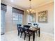 Dining area with neutral walls, chandelier, and window with custom valance at 7407 Excitement Dr, Reunion, FL 34747