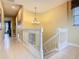 Bright hallway with staircase features tiled floors, chandelier, and natural light at 7407 Excitement Dr, Reunion, FL 34747