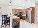 Open concept kitchen featuring stainless steel appliances and breakfast bar at 7407 Excitement Dr, Reunion, FL 34747