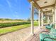 Charming patio with golf course views, featuring comfortable outdoor seating at 7407 Excitement Dr, Reunion, FL 34747