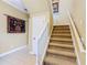 Carpeted staircase with white railing and neutral paint at 7407 Excitement Dr, Reunion, FL 34747