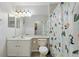 Clean bathroom with a modern vanity, framed mirror, and a fun, decorative shower curtain at 7620 Bay Port Rd # 39, Orlando, FL 32819