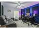 Bonus Room with gray leather couch and blue accent wall with recording studio setup at 7620 Bay Port Rd # 39, Orlando, FL 32819