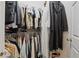 Walk-in closet filled with assorted clothes and shoes at 7620 Bay Port Rd # 39, Orlando, FL 32819