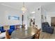 Dining room showcasing a round table, wood chairs, and an adjacent living space at 7620 Bay Port Rd # 39, Orlando, FL 32819