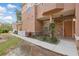 Exterior shot of townhome entrance showing stone facade, landscaping, and covered front porch at 7620 Bay Port Rd # 39, Orlando, FL 32819