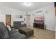 Living room featuring wood flooring, a large TV, and comfortable, neutral-toned furniture at 7620 Bay Port Rd # 39, Orlando, FL 32819