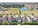 An aerial view of houses near a field and a lake, showcasing the surrounding environment at 9888 Mere Pkwy, Orlando, FL 32832