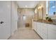 Bright bathroom featuring a double sink vanity, granite countertops, and glass-enclosed shower with bench seating at 9888 Mere Pkwy, Orlando, FL 32832