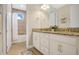 Bright bathroom with a tiled shower/tub, granite countertops, and double sink vanity with gold hardware at 9888 Mere Pkwy, Orlando, FL 32832