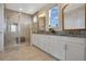 Bright bathroom with double sink vanity, granite countertops, and glass-enclosed shower with bench seating at 9888 Mere Pkwy, Orlando, FL 32832