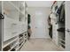 Spacious walk-in closet with custom shelving and drawers for optimal organization and storage space at 9888 Mere Pkwy, Orlando, FL 32832