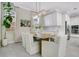 Elegant dining area featuring a modern light fixture, white upholstered chairs, and large windows at 9888 Mere Pkwy, Orlando, FL 32832