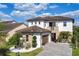 Beautiful two-story home with stone accents, a tile roof, and a well-manicured front yard at 9888 Mere Pkwy, Orlando, FL 32832