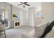 Bright sitting room with decorative fireplace, a door leading to a balcony, and a ceiling fan at 9888 Mere Pkwy, Orlando, FL 32832