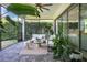 Inviting screened patio featuring comfortable seating and lush tropical plants at 9888 Mere Pkwy, Orlando, FL 32832