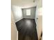 Bright, empty bedroom with dark wood floors, a window, and neutral walls, ready for your personal touch at 1010 Loch Vail # 1125, Apopka, FL 32712