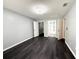 Spacious bedroom with wood flooring, walk-in closet, and adjacent bathroom at 1010 Loch Vail # 1125, Apopka, FL 32712