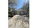 Condo exterior featuring multiple garages, stone accents, and a well-maintained driveway at 1010 Loch Vail # 1125, Apopka, FL 32712