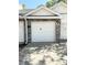 Garage exterior with a white door, stone accents and an exterior lamp at 1010 Loch Vail # 1125, Apopka, FL 32712