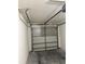The garage features an automatic garage door, concrete floor, and white walls at 1010 Loch Vail # 1125, Apopka, FL 32712