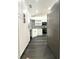 Updated kitchen with white cabinets, stainless steel appliances, and a decorative black and white tile backsplash at 1010 Loch Vail # 1125, Apopka, FL 32712
