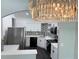 Modern kitchen featuring white cabinets, quartz countertops, stainless steel appliances, and decorative backsplash at 1010 Loch Vail # 1125, Apopka, FL 32712