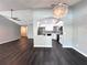 Open-concept condo living room with modern flooring and a view of the kitchen at 1010 Loch Vail # 1125, Apopka, FL 32712