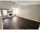 Spacious living room featuring dark wood floors, a white fireplace, and natural light from two large windows at 1010 Loch Vail # 1125, Apopka, FL 32712