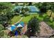 Aerial shot of the community playground and tennis courts, nestled among trees at 10783 Satinwood Cir, Orlando, FL 32825