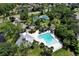 Aerial view showcasing the community pool, tennis courts, and lush landscaping at 10783 Satinwood Cir, Orlando, FL 32825