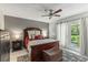 Bedroom with a ceiling fan, a door to the outside, and neutral walls and tiled flooring at 10783 Satinwood Cir, Orlando, FL 32825