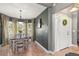 Cozy dining room featuring a decorative light fixture, bay window, and front door at 10783 Satinwood Cir, Orlando, FL 32825